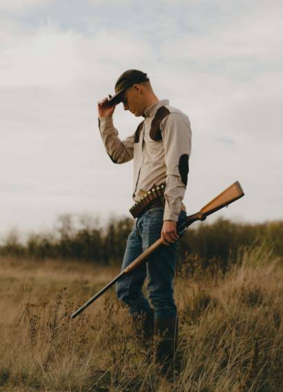 man-with-shotgun-backround-20percent man-with-shotgun-backround-20percent